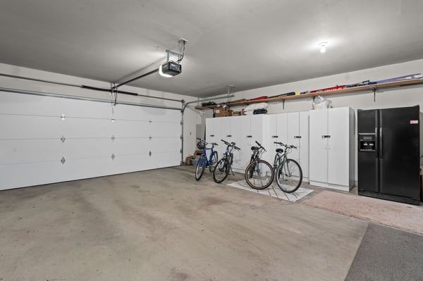 Spacious garage featuring organized storage, ready bikes for your adventures, and a refrigerator—perfect for easy beach prep and keeping your drinks cold after a day exploring.