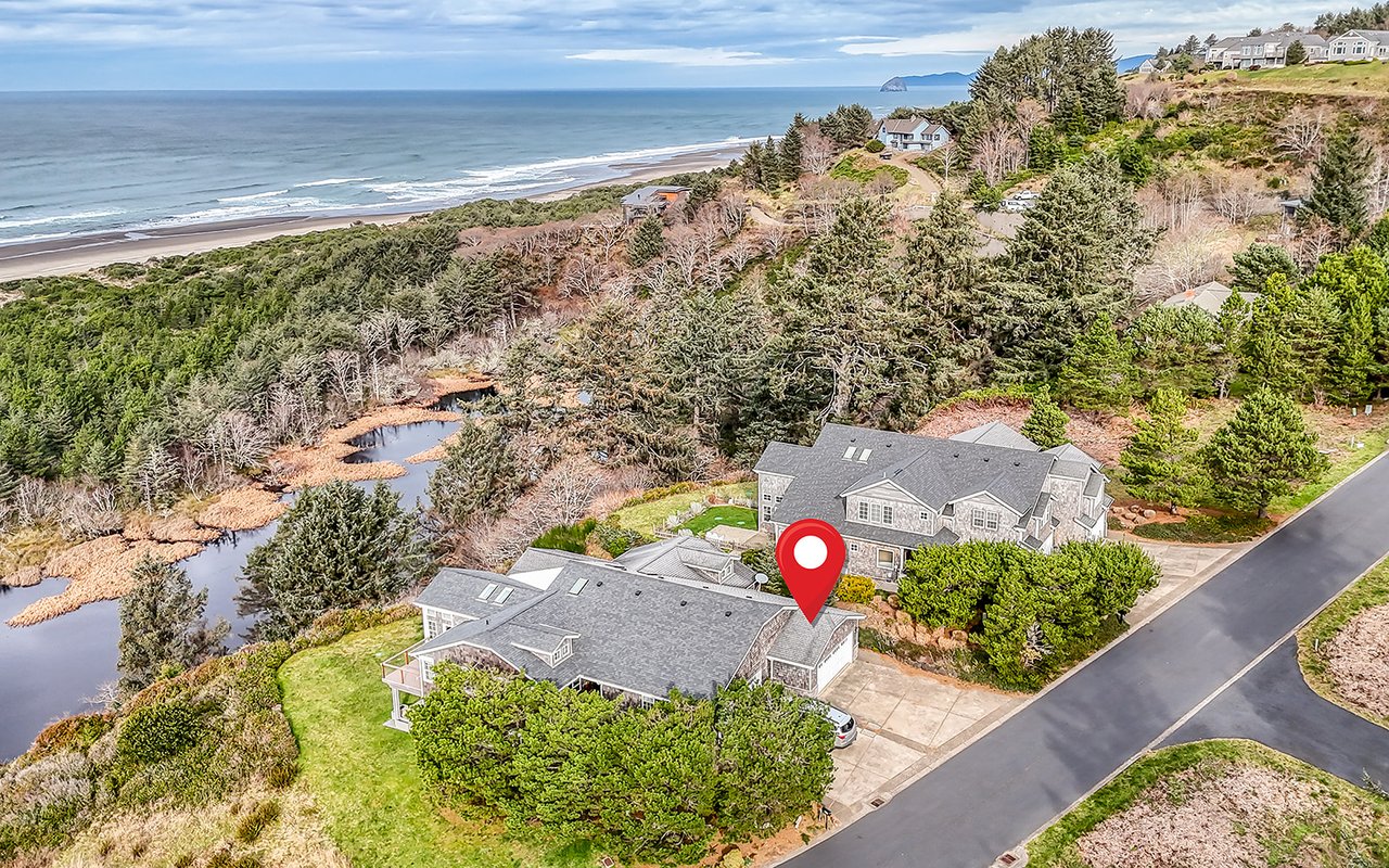 Stunning coastal property showcasing prime beachfront location with oceanfront views and convenient beach access surrounded by natural landscape.