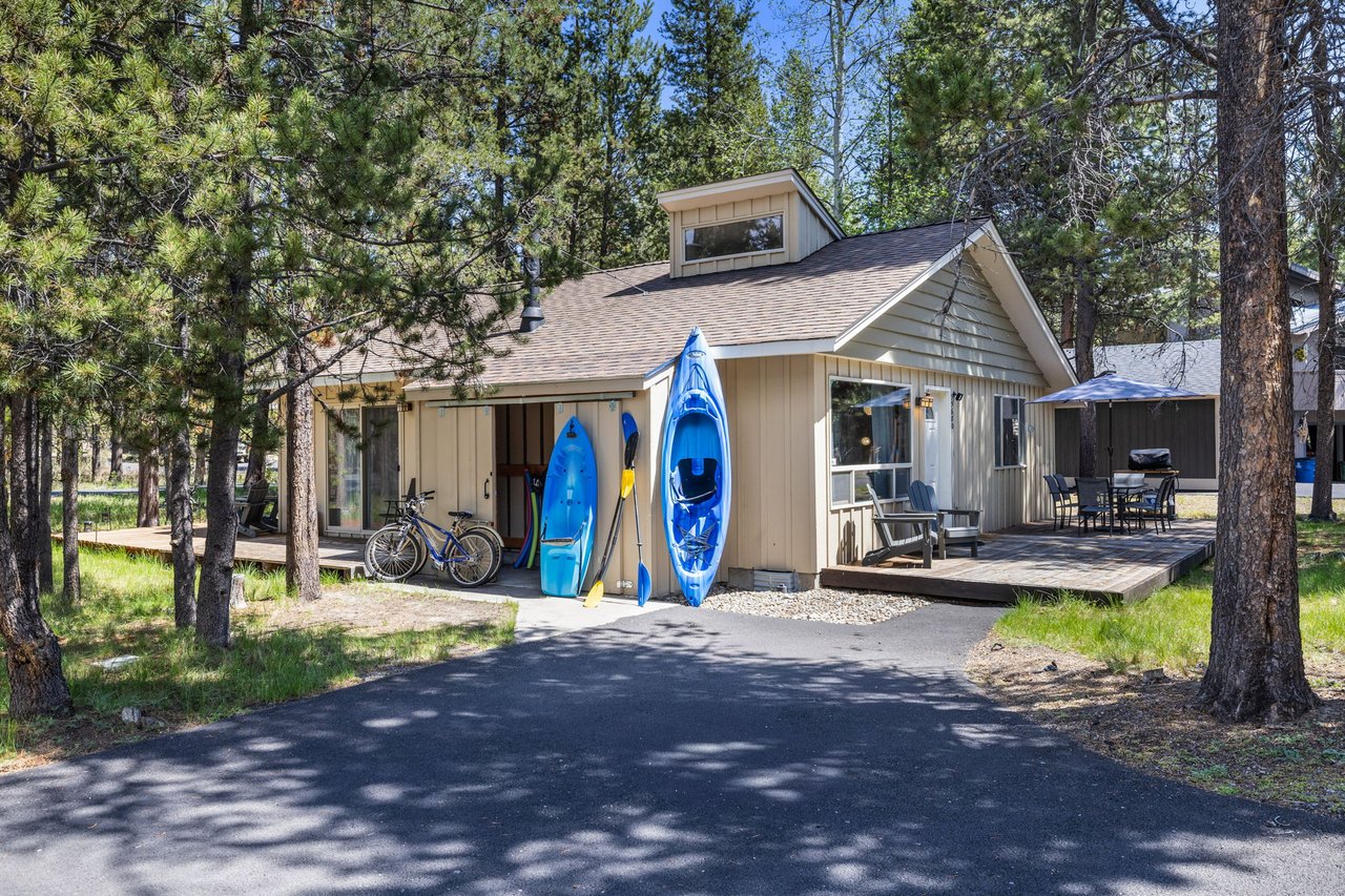 Charming vacation cabin nestled among towering pines, featuring adventure-ready kayaks, bikes, and private parking. The serene forest setting offers a peaceful retreat with modern conveniences.