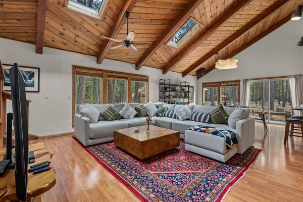 Unwind in this open living space with soaring wood ceilings and forest views through every window.