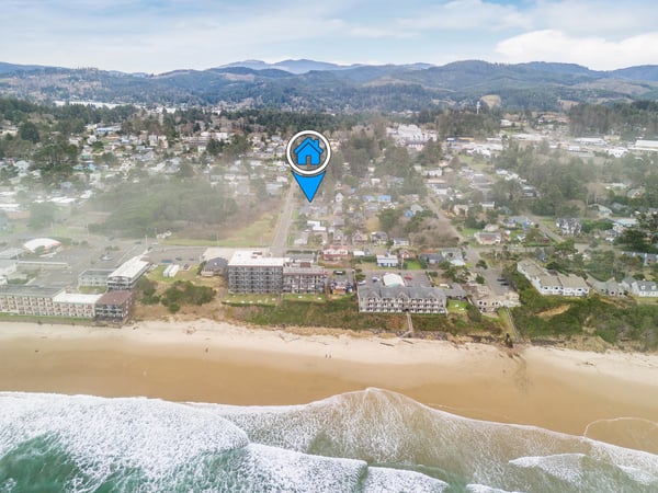 Coastal property nestled between pristine beach and rolling forested hills, offering stunning ocean access and mountain views.