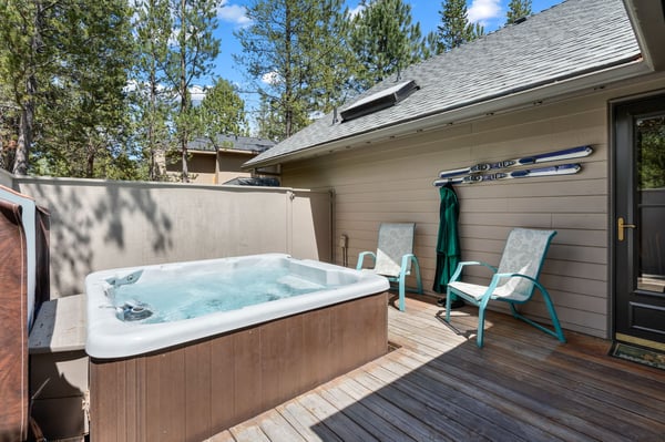 Soak away your cares in your private hot tub on the deck, surrounded by tall pines. Two lounge chairs await your relaxation under the warm sun.