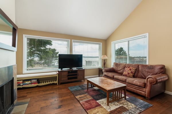 Unwind in your bright, welcoming living room with rich leather seating and warm wood floors beneath your feet.
