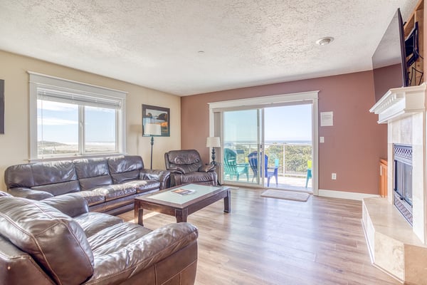 Sink into plush leather seating while enjoying panoramic views through expansive windows in your spacious living area.