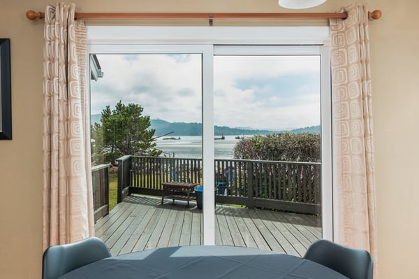 Enjoy breathtaking water views from your dining area, where sliding doors open to a private deck overlooking tranquil waters and distant mountains.