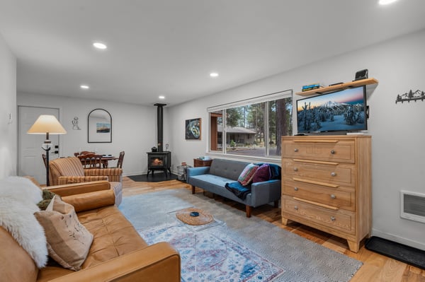 Settle into your cozy living space with soft leather seating, warm wood stove ambiance, and modern entertainment—perfect for unwinding after mountain adventures.