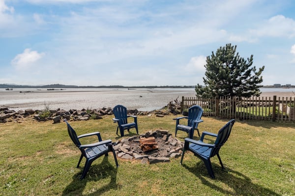 Gather around your private fire pit with Adirondack chairs, overlooking pristine beach sands. Perfect for evening conversations under starlit skies.