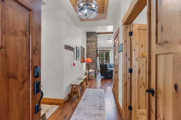 Step into your rustic retreat where warm wood beams and stone accents create a cozy mountain cabin atmosphere perfect for unwinding.