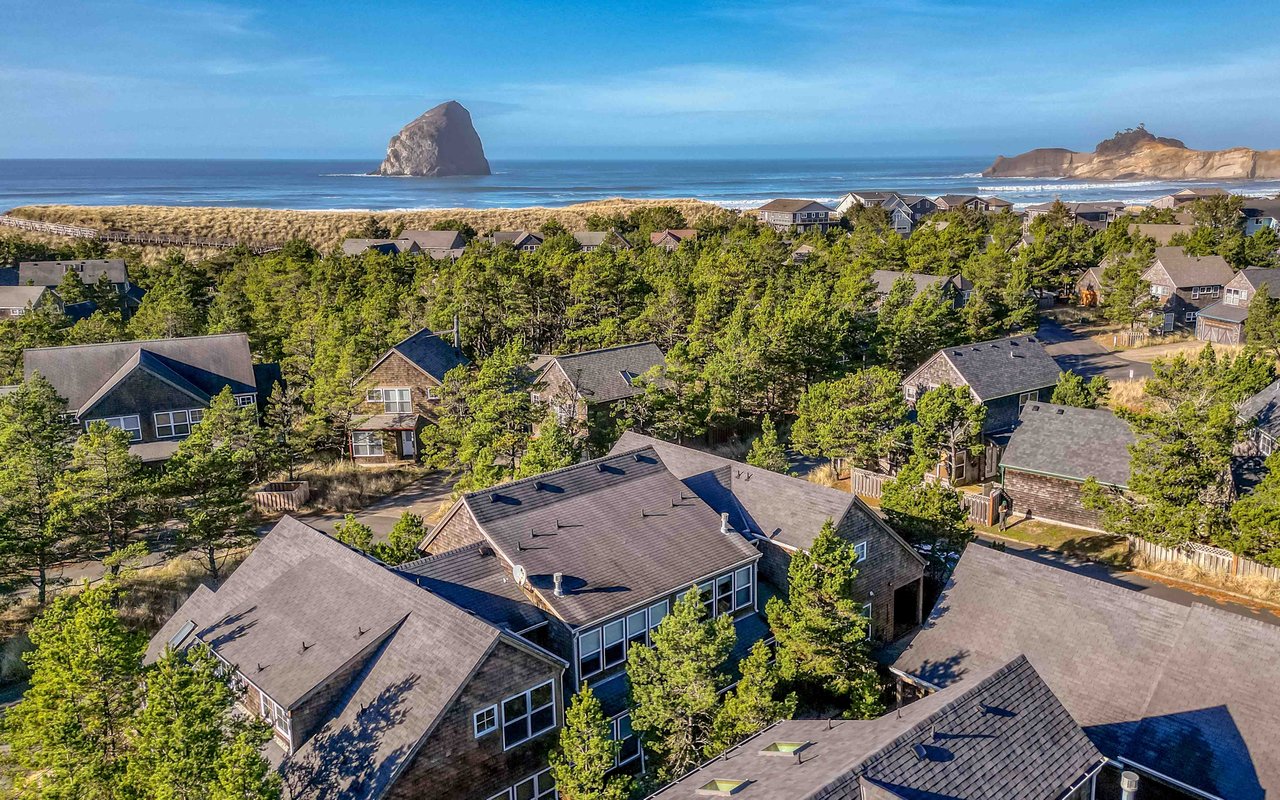 Coastal community nestled between towering sea stacks and sandy dunes, offering serene Pacific Northwest charm.