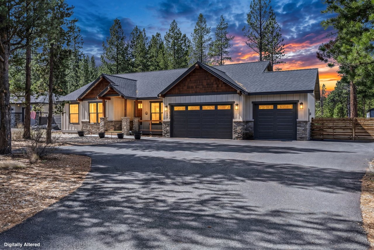 Modern mountain retreat with warm stone and wood facade, nestled among towering pines with spacious parking and dramatic sunset skies.