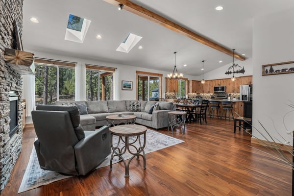 Unwind in your stunning open-concept retreat with soaring ceilings, cozy stone fireplace, and gleaming hardwood floors that flow seamlessly to the gourmet kitchen.