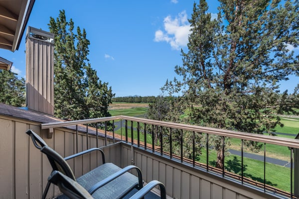 Step onto your private balcony and take in sweeping views of the lush golf course framed by tall pines and open sky—perfect for morning coffee or evening unwinding.