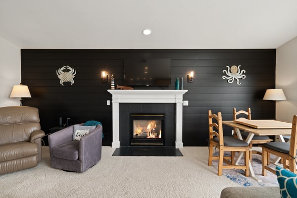 Cozy up by the fireplace in this inviting living space with nautical charm, perfect for relaxing evenings and quality time together.