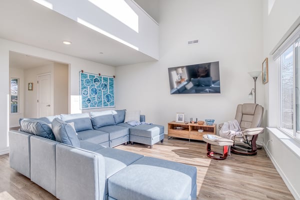 Unwind in your bright living room with plush sectional seating and vaulted ceilings that create an airy, spacious atmosphere.
