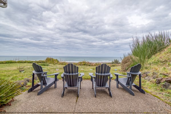 Four Adirondack chairs perfectly positioned overlooking the ocean, where you can relax with loved ones and watch the waves roll in.