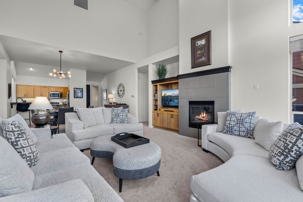 Relax in your spacious living room with cozy fireplace and modern amenities, perfect for unwinding after mountain adventures.