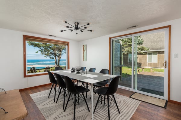 Gather around this stunning dining table where ocean views frame every meal and conversation flows as beautifully as the coastal scenery outside your window.