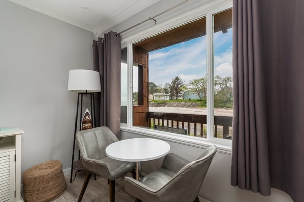 Settle into your private nook and enjoy serene water views through the open window. This cozy corner offers a perfect spot for morning coffee or quiet moments.