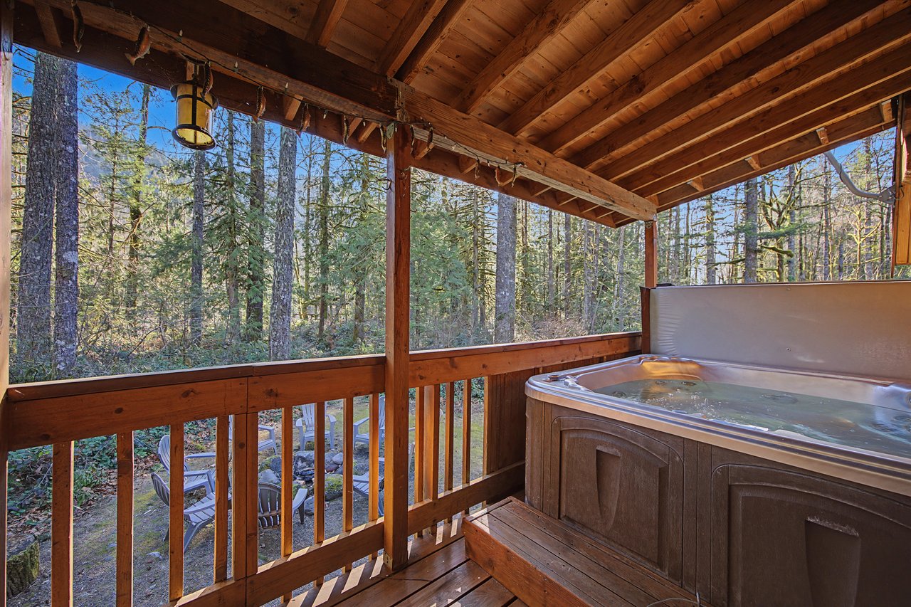 Soak your worries away in this private hot tub, surrounded by towering forest views on your secluded deck retreat.