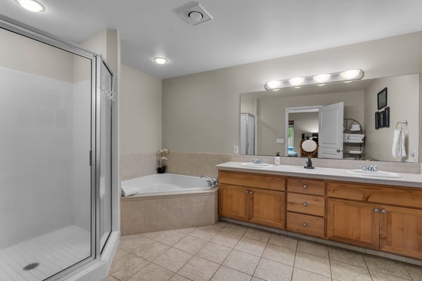 Step into your private spa-like bathroom with dual vanities, a luxurious soaking tub, and a spacious walk-in shower—designed for ultimate comfort and relaxation.