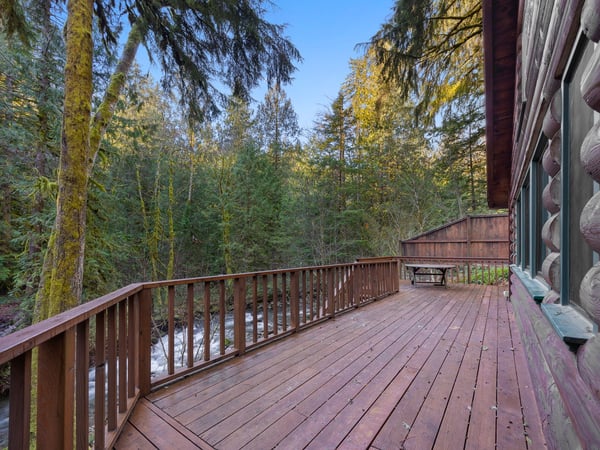 Step onto your private deck surrounded by towering evergreens, where morning coffee feels magical among the forest canopy.
