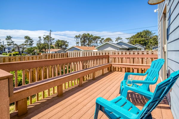 Fenced backyard, lounge chairs, and deck