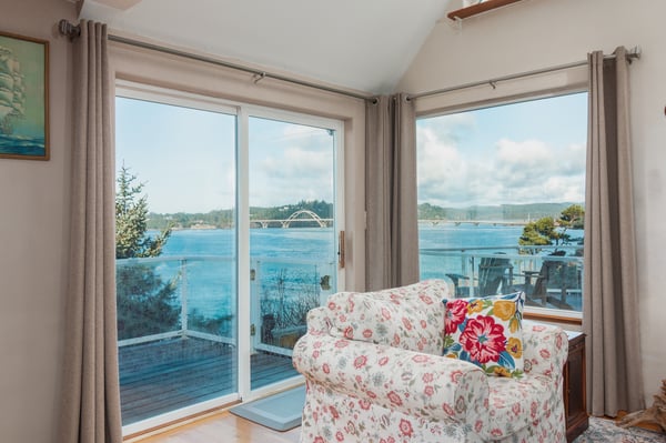 Sink into this cozy floral armchair and let the stunning waterfront views through floor-to-ceiling windows become your daily backdrop.