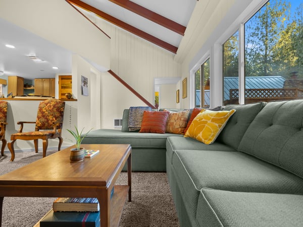 Sink into this plush sectional sofa and unwind in your bright, airy living space with soaring ceilings and garden views.