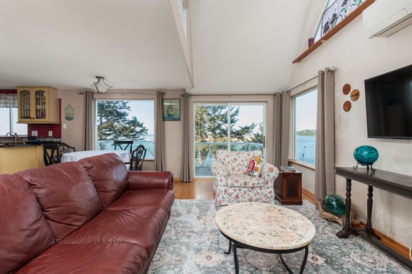 Relax in your bright living space with stunning lake views through expansive windows, perfect for morning coffee or evening conversations.