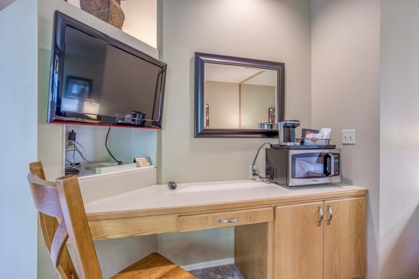 Desk in Bedroom with TV and Microwave